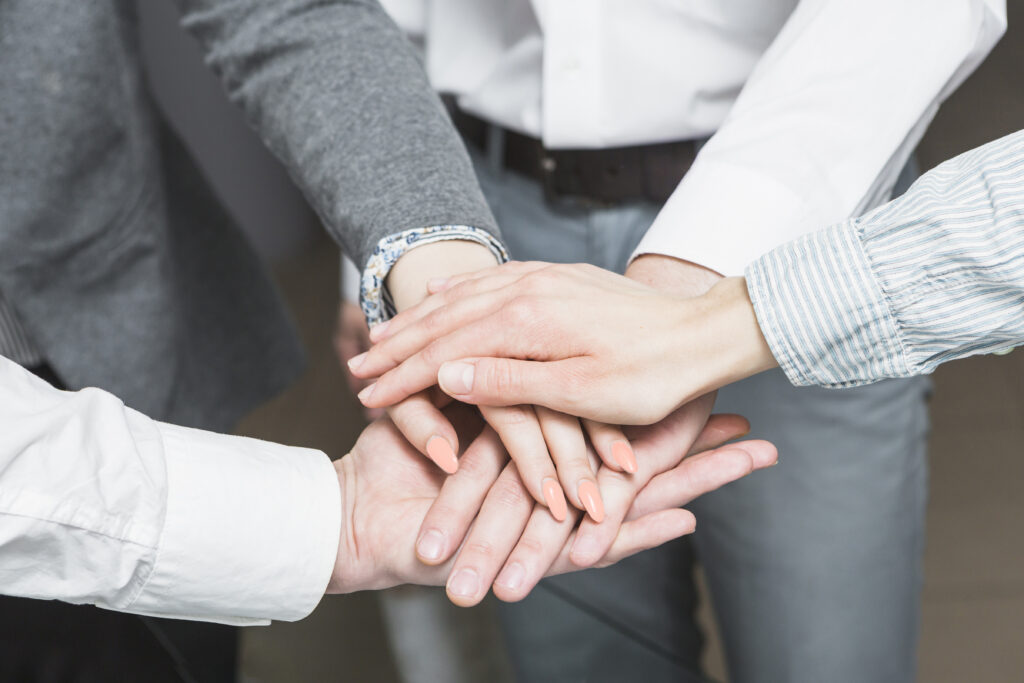 group-businesspeople-stacking-hands motivated