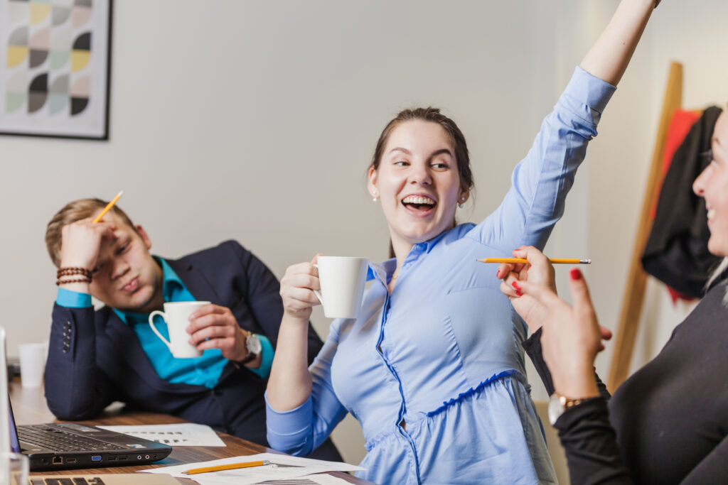 office-workers-sitting-table-smiling